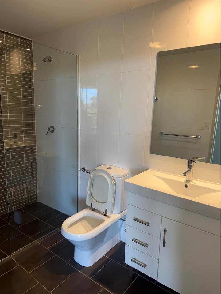 Modern bathroom vanity and toilet after cleaning