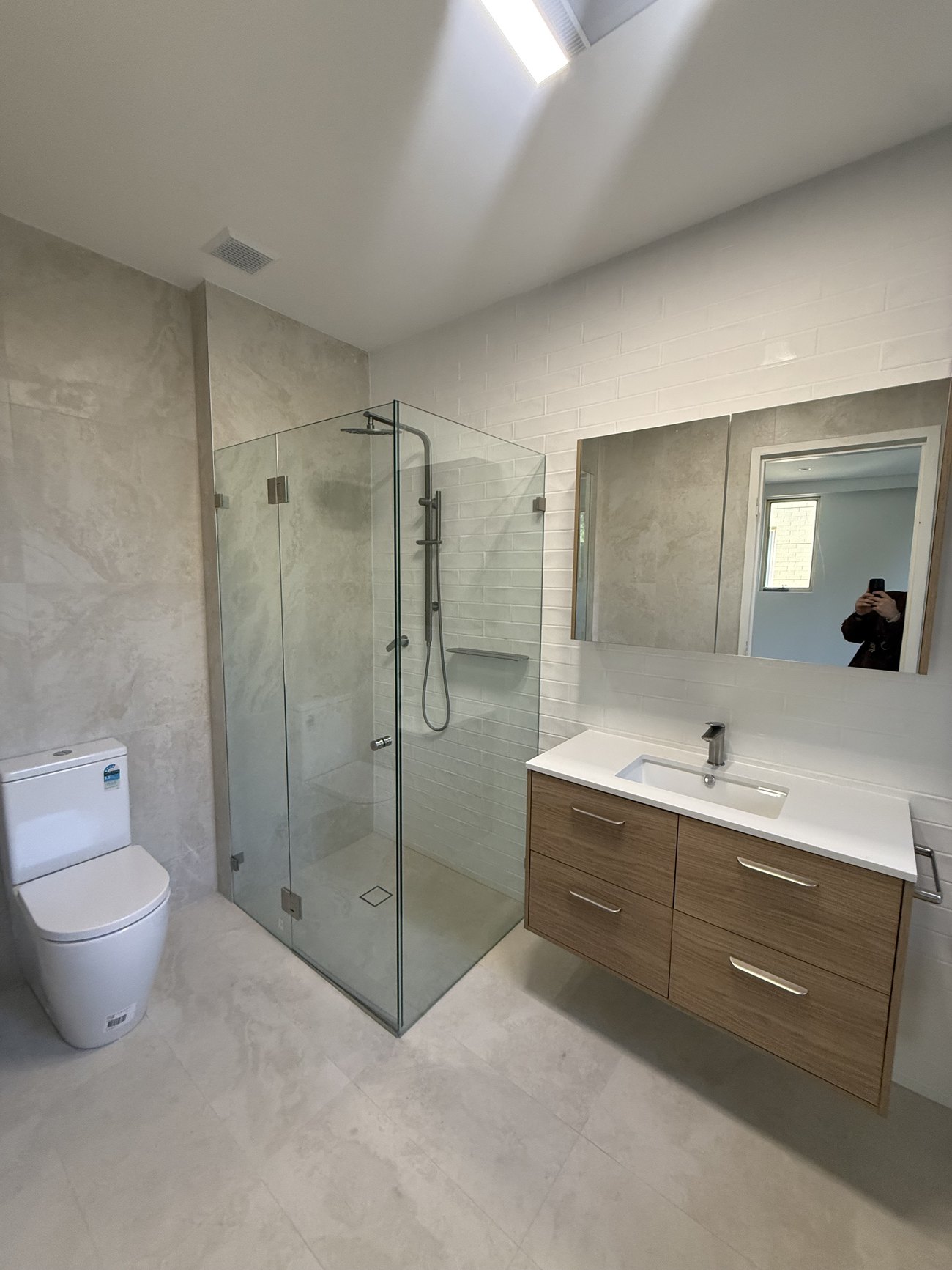 Premium bathroom with glass shower and floating vanity, cleaned